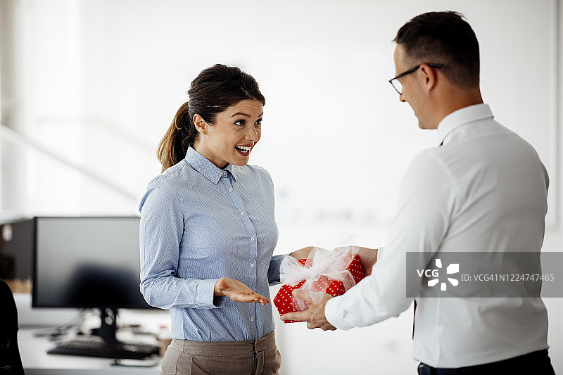 商人向女同事赠送礼品图片素材