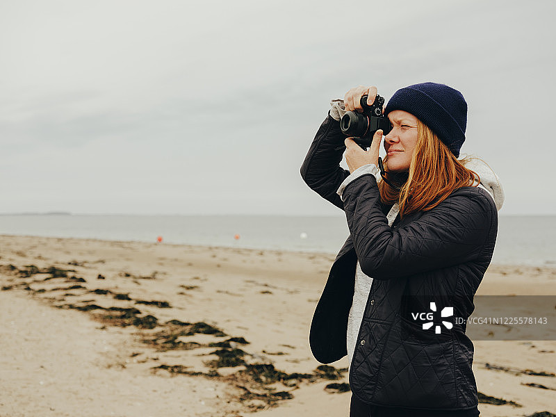 女人在苏格兰海滩上拍照图片素材