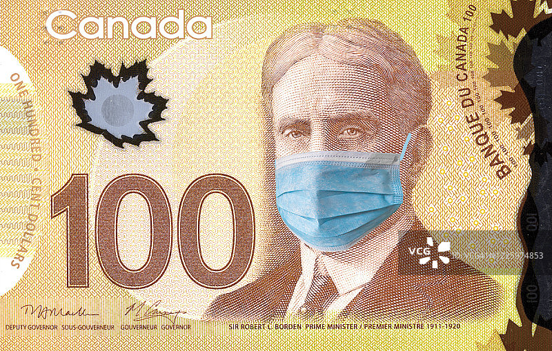 加拿大隔离，带有医用口罩的100加元纸币，关于流行病和预防冠状病毒的概念图片素材