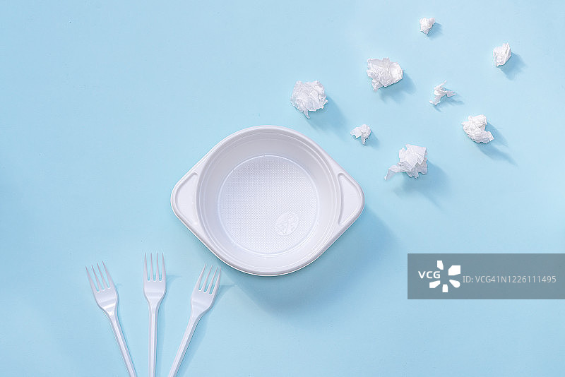 塑料餐具社会环境问题地球塑料污染蓝色背景上的白色塑料图片素材