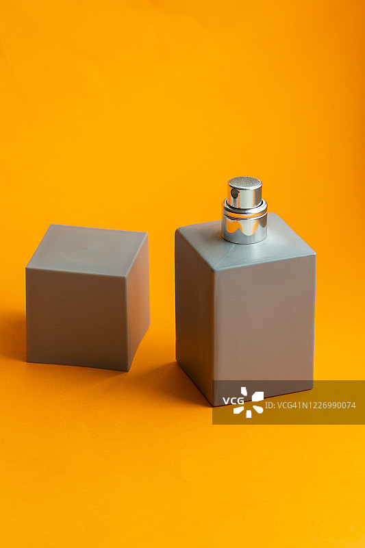 彩色背景上的灰色香水瓶图片素材