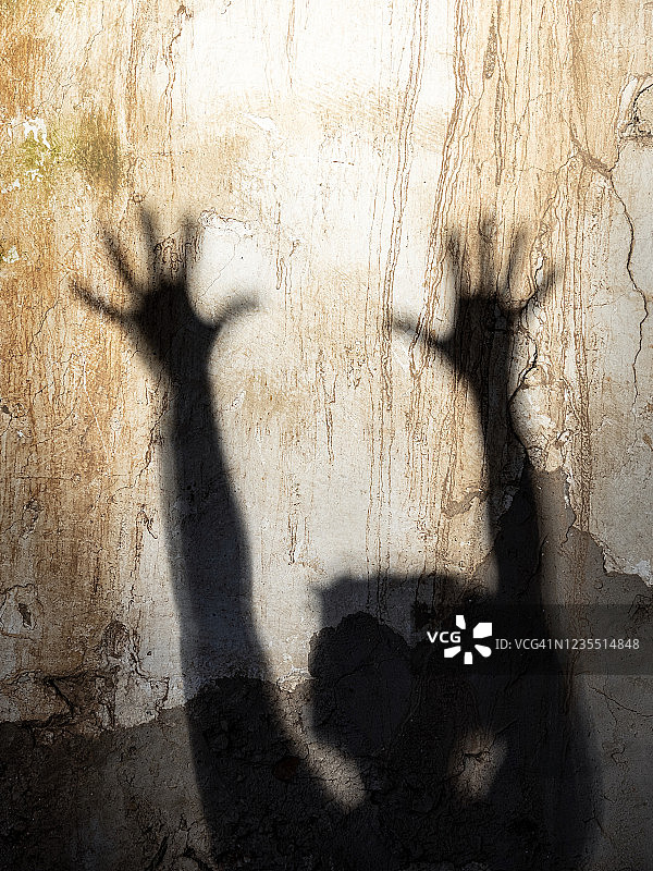 举起的手的阴影，女人伸出五指，手掌朝上。图片素材