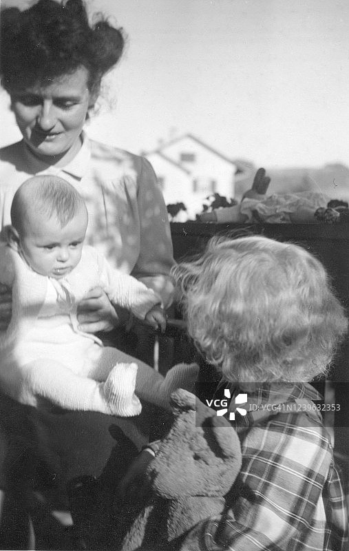 母亲和两个女儿在阳台上，1947年，瑞士图片素材