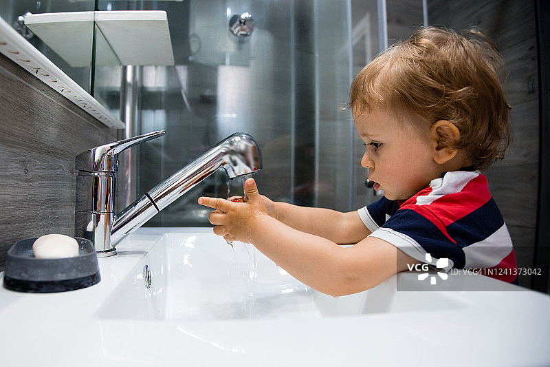 小男孩在浴室洗手图片素材