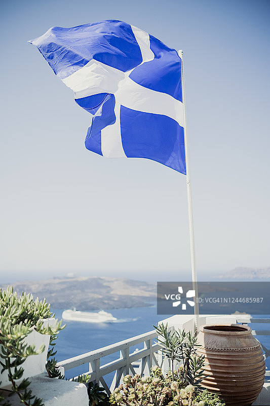 仰视晴朗蓝天下的希腊国旗图片素材