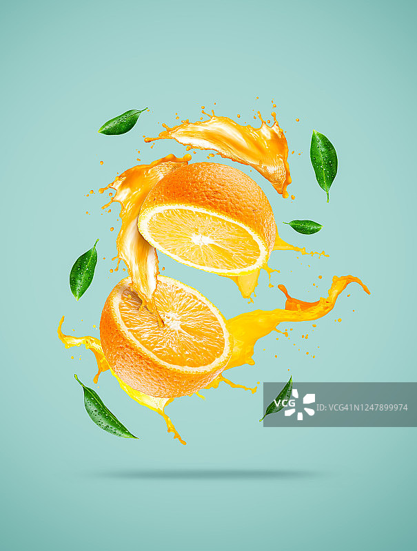 橙子切片和果汁飞溅与绿叶图片素材