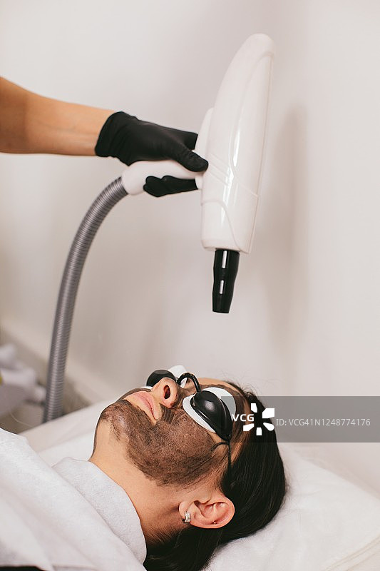 女人接受碳粉焕肤美容护理图片素材