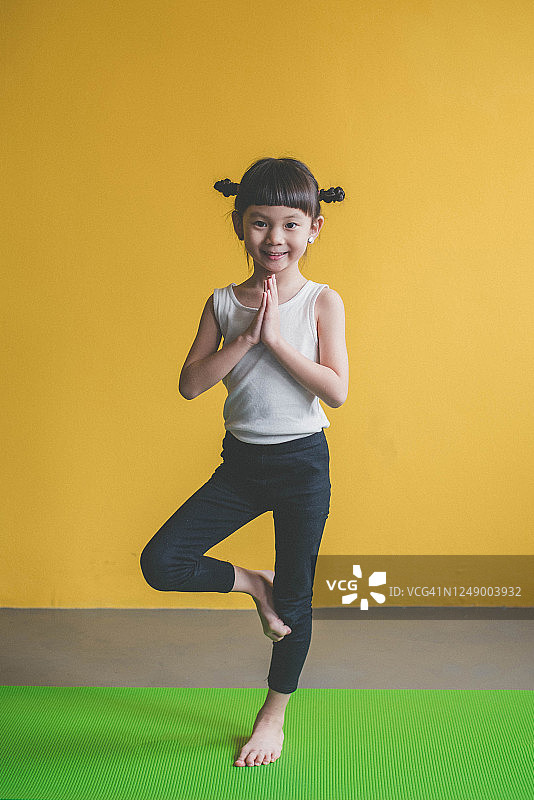 亚洲可爱女孩在家做健身运动图片素材