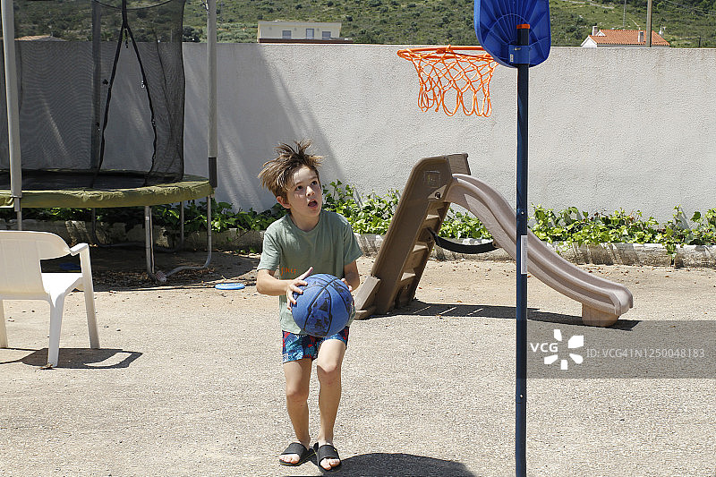 男孩在球场打篮球图片素材