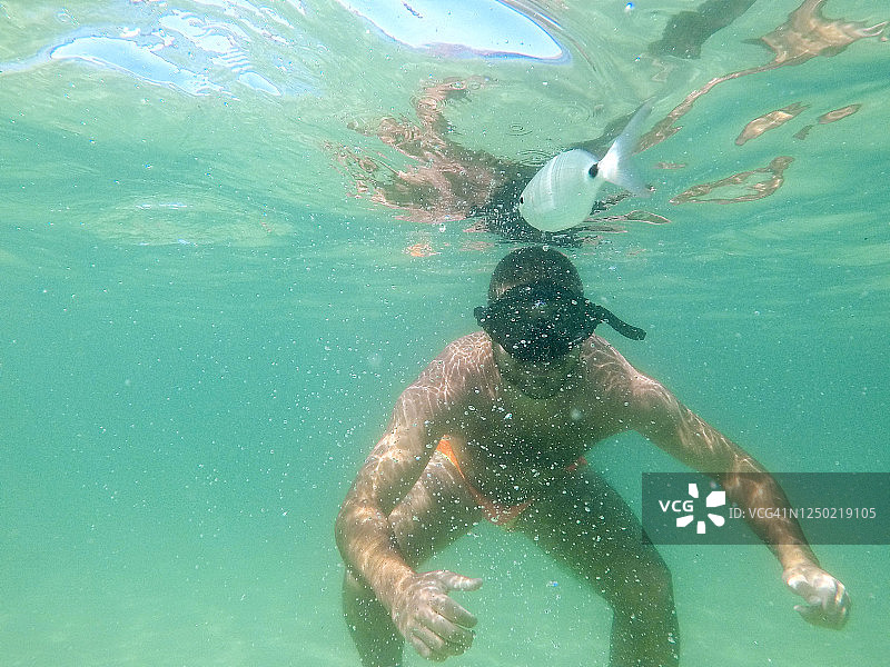 年轻男人水下浮潜。图片素材