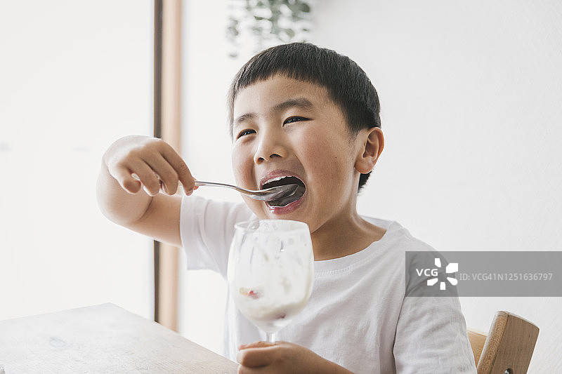 男孩在家吃草莓冻糕图片素材