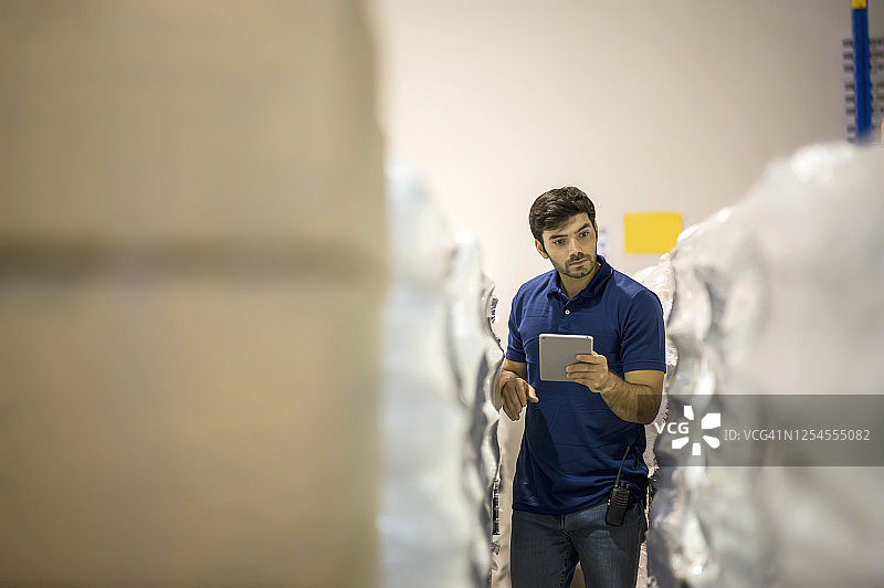 仓库管理员使用平板电脑检查配送仓库中的产品库存图片素材