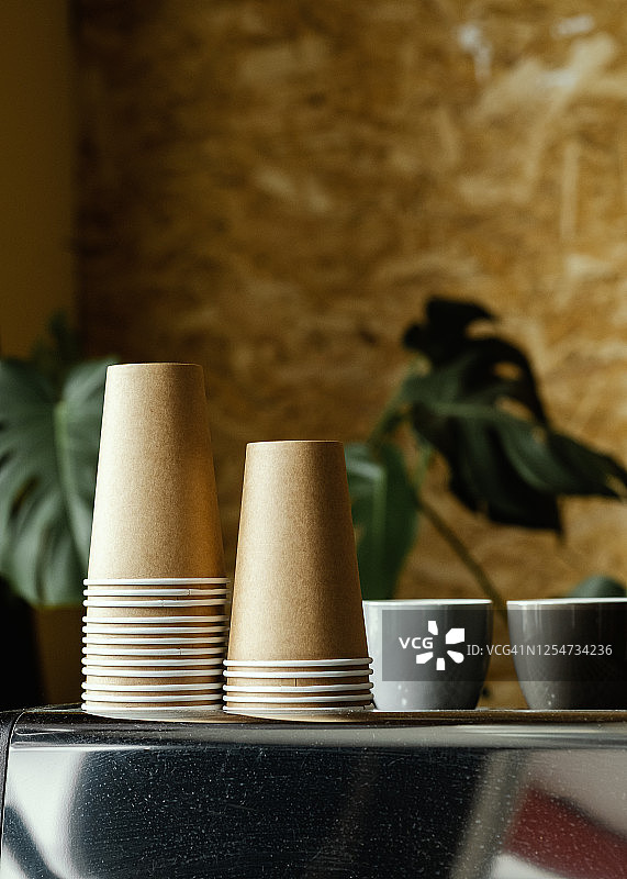 咖啡机上未使用的纸质咖啡杯和陶瓷浓缩咖啡杯图片素材
