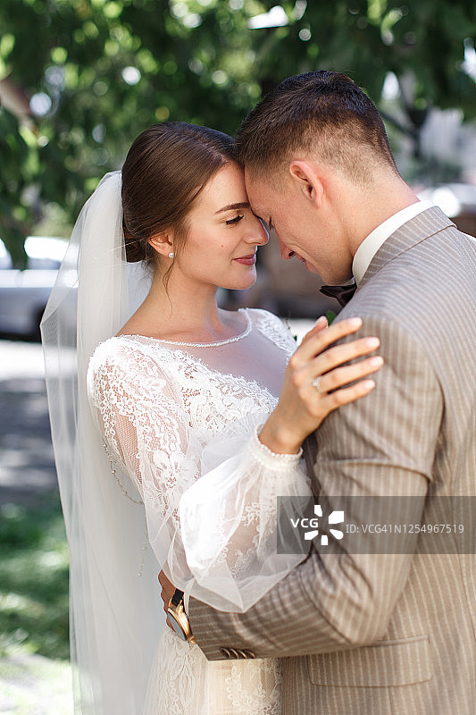 快乐的年轻新婚夫妇拥抱微笑图片素材