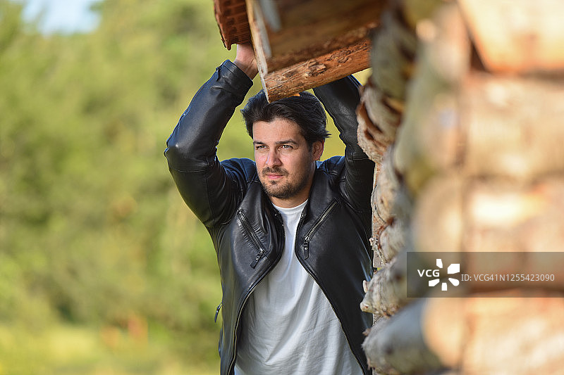 身穿黑色皮夹克的年轻英俊男人图片素材