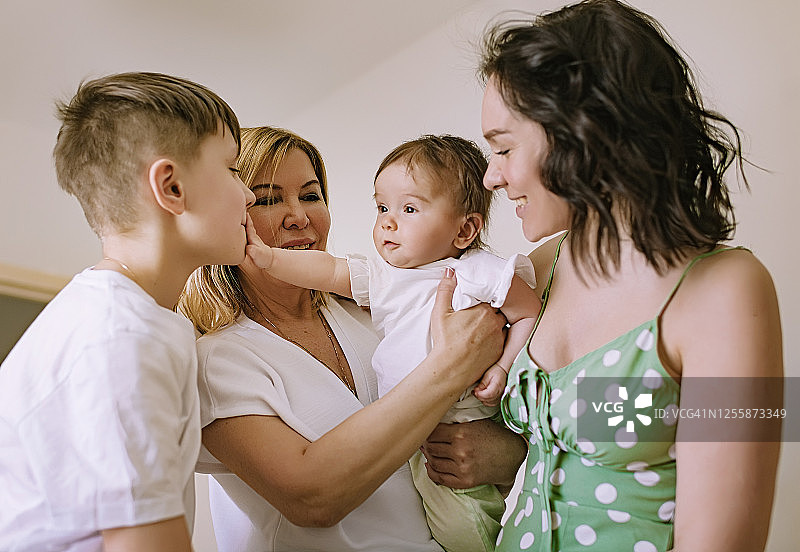 三代同堂的家庭：祖母、母亲和两个孩子在家的生活方式图片素材