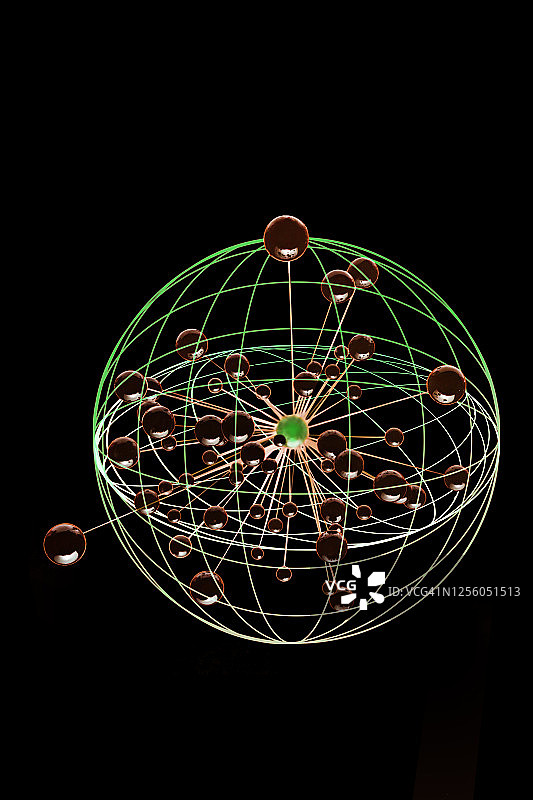 双重曝光抽象图像：棕色球体从绿色球体中心向外扩散图片素材