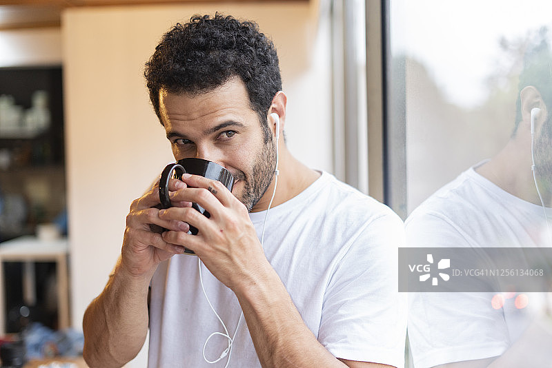 早上听音乐喝咖啡的拉丁裔男人图片素材