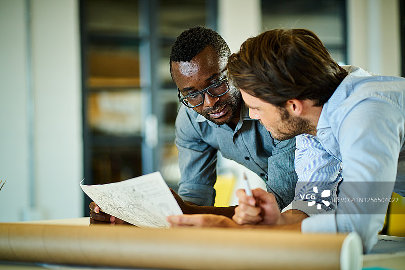 办公室里一起查看设计方案的两位建筑师图片素材