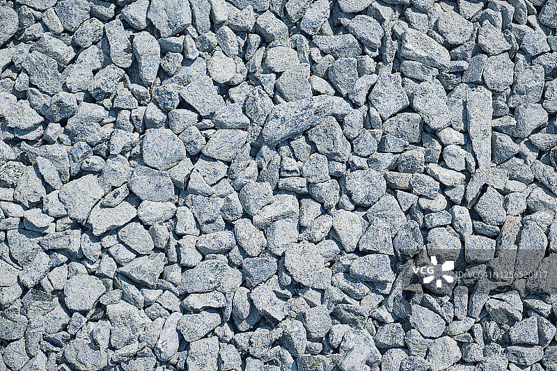 花岗岩砾石堆特写：粗糙的无缝纹理建筑材料背景图片素材