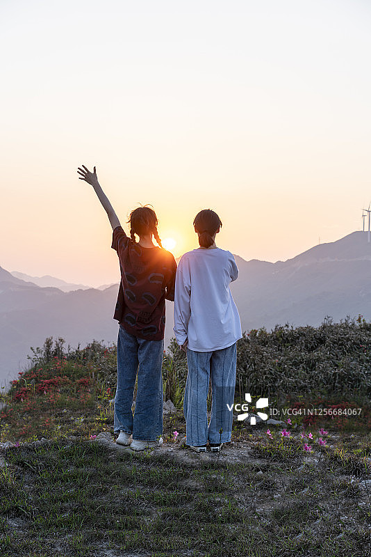 观看日落的亚洲年轻女性图片素材