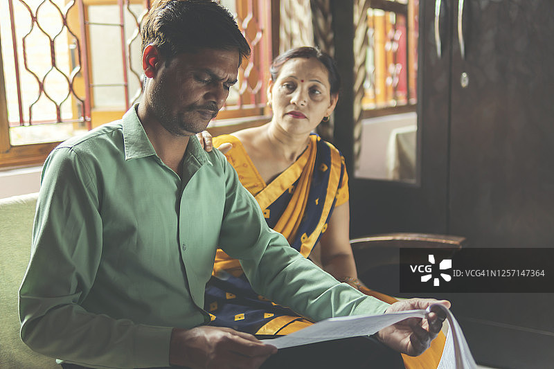 为账单发愁的印度中年夫妇图片素材
