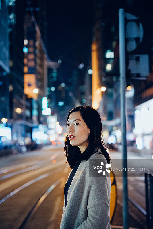 自信亚洲女人夜间城市街头图片素材