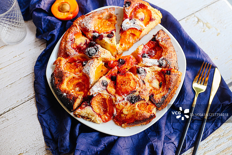 夏日烤杏子浆果派，配蓝色布艺木质白桌。乡村风格。图片素材