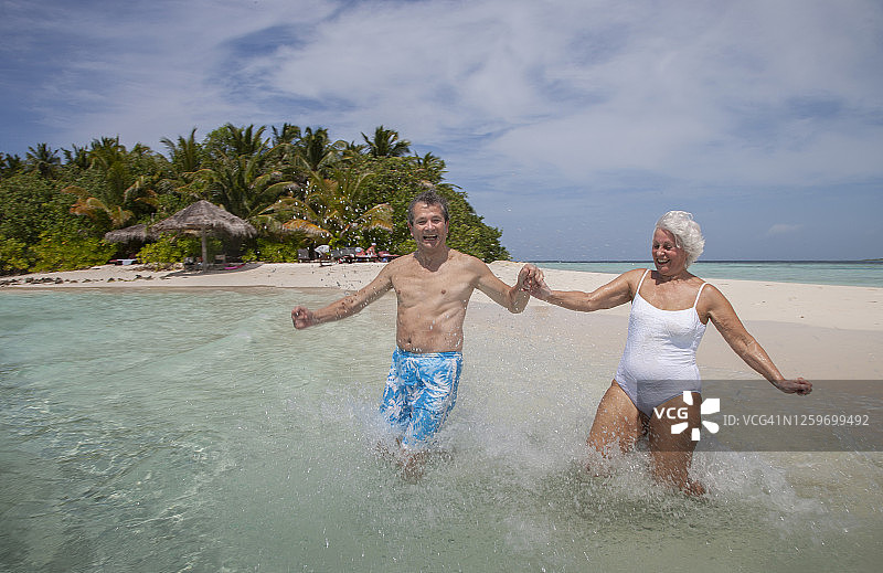 老年夫妇在热带海滩上图片素材