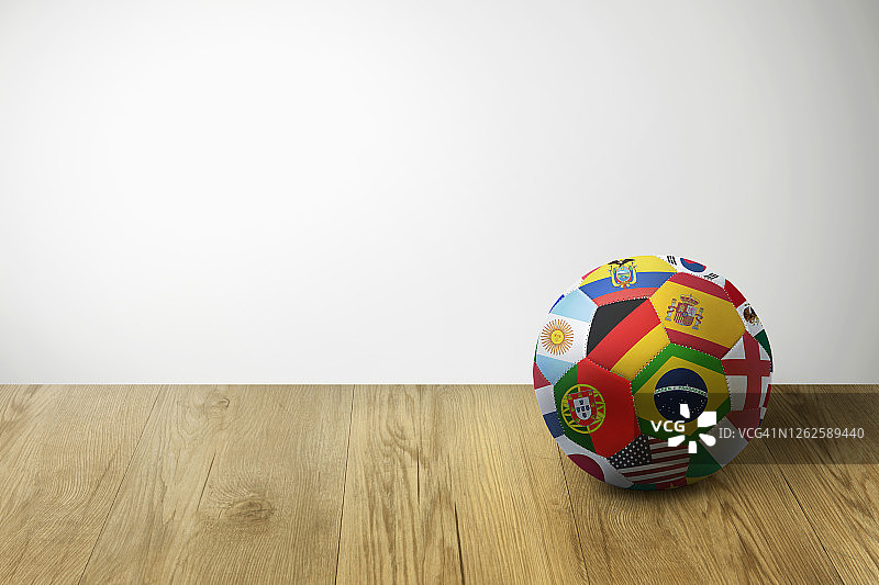 放在拼花地板上的带世界各国国旗的足球图片素材