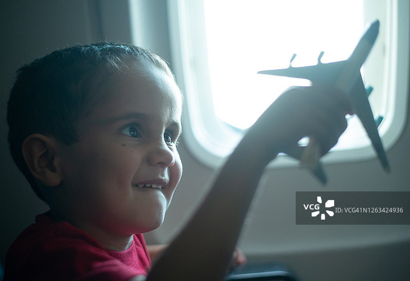 男孩在飞机上玩玩具飞机图片素材