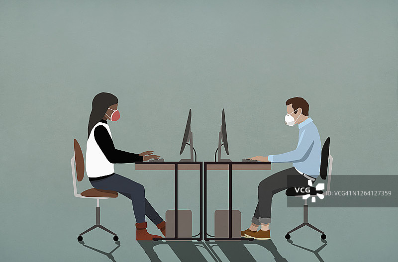 戴口罩的商务人士在电脑前工作图片素材