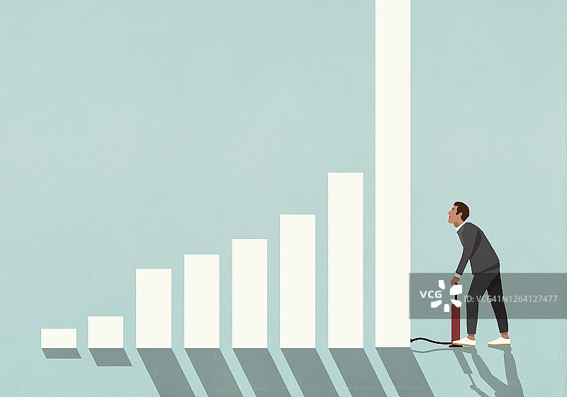 男商人用轮胎泵给条形图充气图片素材