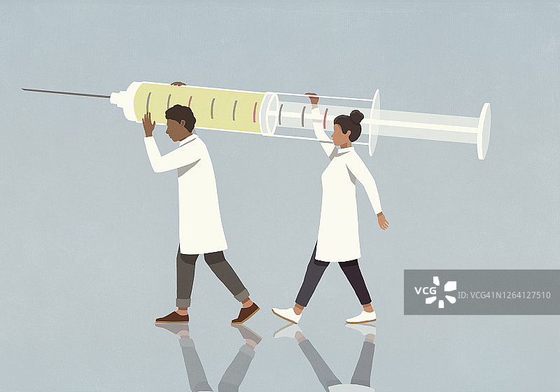 携带大注射器的医生图片素材