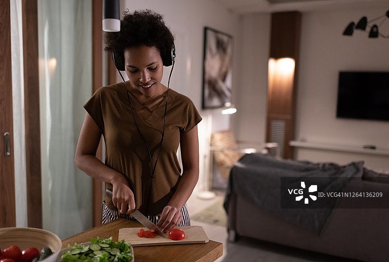 混血女人一边做饭一边听音乐图片素材