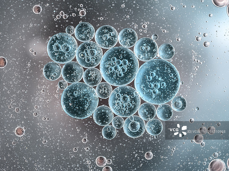 蓝色金属液体背景上的气泡和液滴形成的抽象形状和纹理特写图片素材