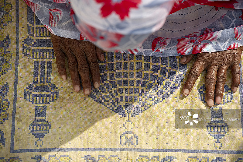 穆斯林女性在清真寺地毯上向真主祈祷图片素材