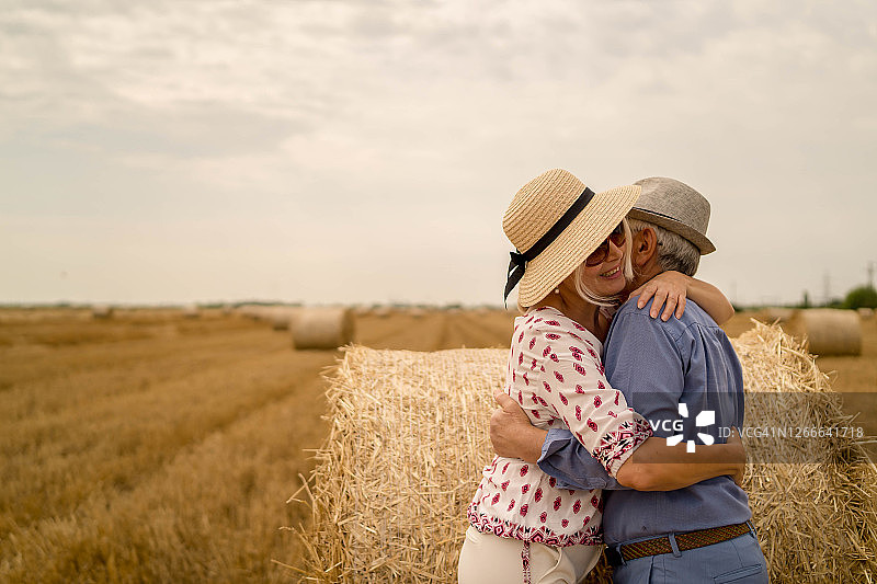在干草堆上玩耍的情侣图片素材