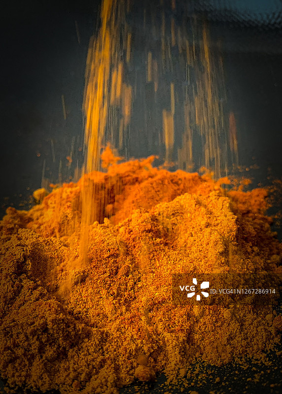 倾倒咖喱和辣椒粉的混合物图片素材