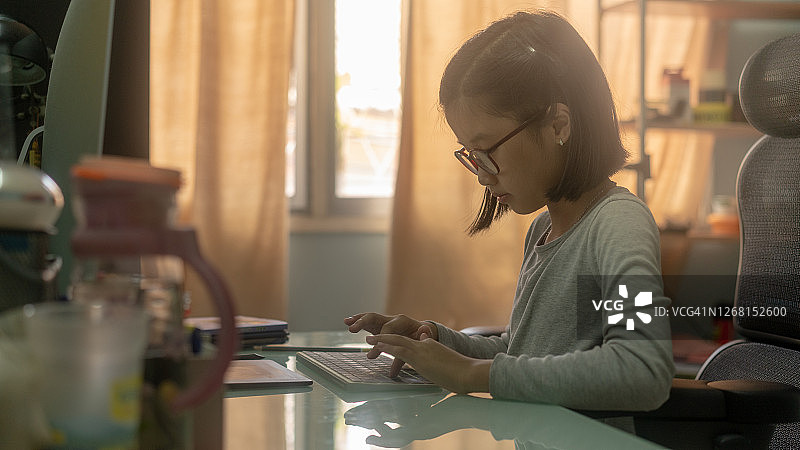 专心打字的女性小学生图片素材