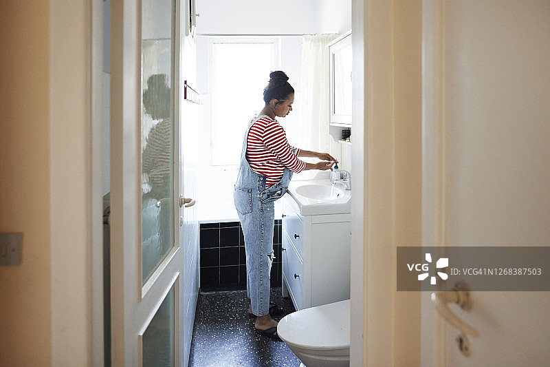 女人在浴室用消毒液洗手图片素材