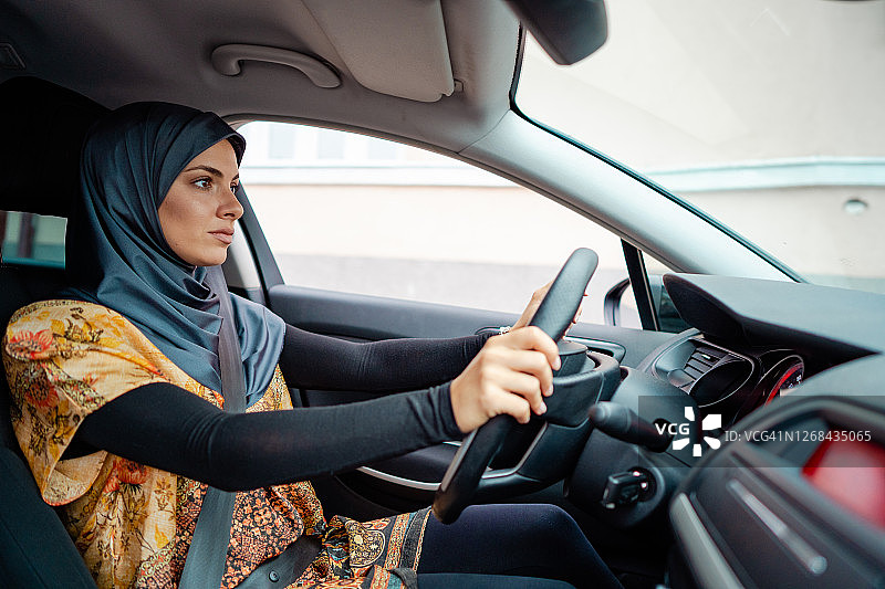 独立驾驶汽车的穆斯林妇女图片素材