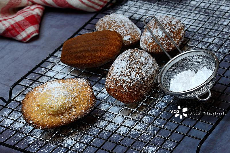德国玛德琳蛋糕与糖粉筛图片素材