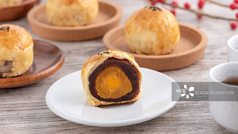 中秋节月饼蛋黄酥，在明亮的木桌上搭配文案的顶视图设计概念图片素材