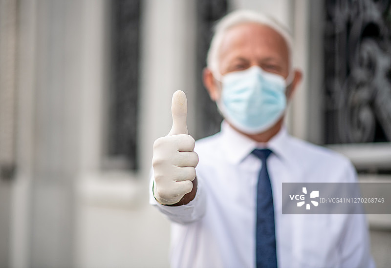 穿西装戴口罩的男人竖起大拇指，防疫图片素材