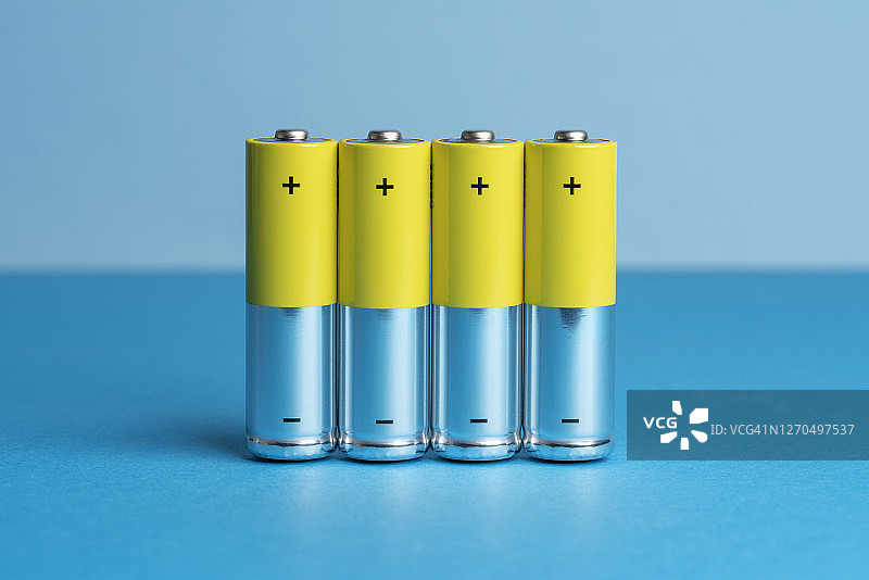 蓝色背景上的四个黄色电池图片素材