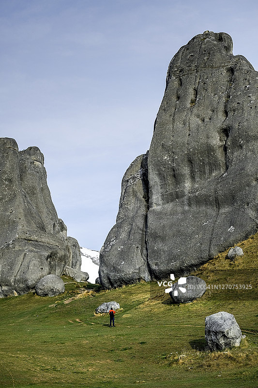 新西兰南岛城堡山的风景，一个人站在大石头前图片素材