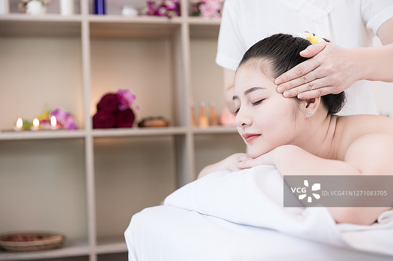 年轻亚裔女性享受Spa按摩护理图片素材
