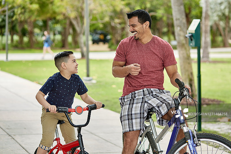 骑自行车的拉美裔父子的抓拍肖像图片素材