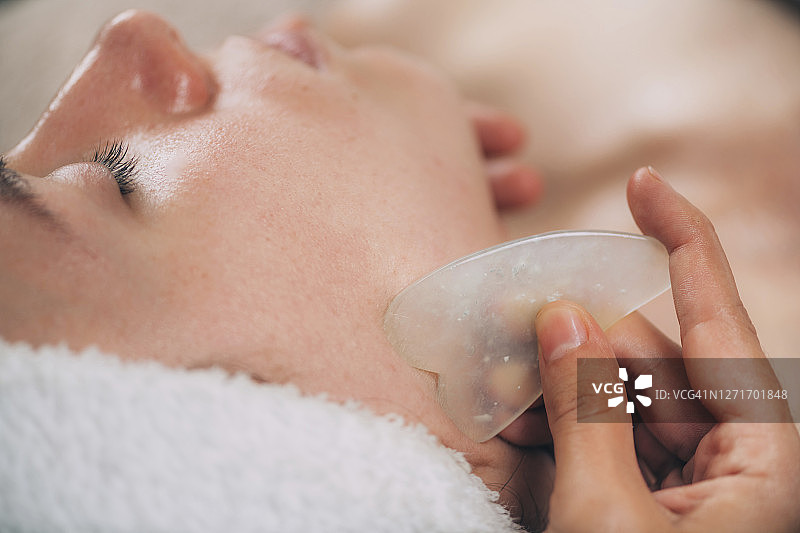 使用玉石进行瓜痧面部塑形技术图片素材